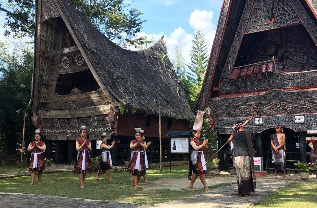 Toba Batak dancers in traditional regalia  perform bowl dance